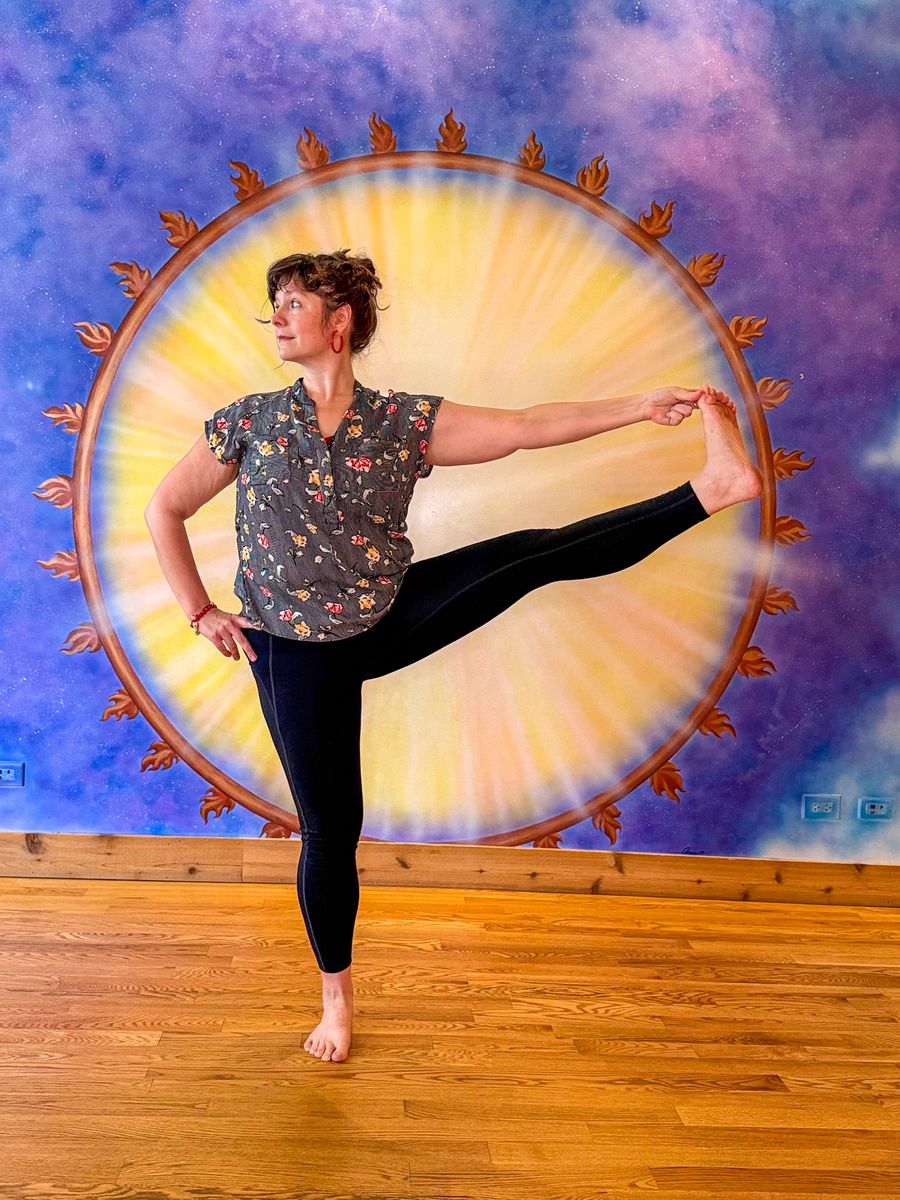 A standing balance holding one foot out to the side, in front of the sun mural